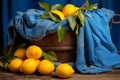 still life with lemons and blue cloth on wooden table Royalty Free Stock Photo