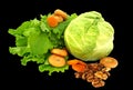 Still life of lettuce, cabbage, dried fruit, apple, drying, nuts and dried apricots Isolated on black background