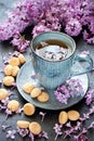 Still life with  lilac flowers and tea with cookies Royalty Free Stock Photo