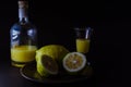 Limoncello traditional italian lemon liqueur with bottle, glass and fresh lemon halves Royalty Free Stock Photo