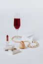 A still life with a little white envelop, a faded rose bud, a coral necklace, a lipstick, a box with the silver earrings Royalty Free Stock Photo