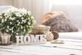 Still life in the living room with wooden inscription home Royalty Free Stock Photo