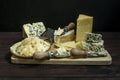 Still life with a lot of assorted cheese with blue cheese, parmesan flakes, Royalty Free Stock Photo