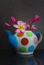 Still life Lovely plumeria flower in colourful tea pot