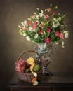 Still life with luxurious bouquet of multicolored flowers and fruit basket