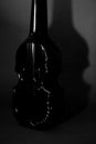 Still life a luxurious glass bottle of cognac, a form of a violin, with an alcoholic drink, abstraction Royalty Free Stock Photo