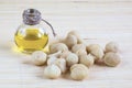 Still life with Macadamia nuts and bottle of oil