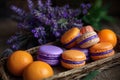 Whicker basket with purple and orange macarons near lavender flowers, fresh oranges and orange juice Royalty Free Stock Photo