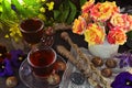 Still life with magic wannds, cups and flowers on witch ritual table.