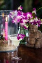 Still life with margarita cocktail, orchid flowers butning candle and hotei Royalty Free Stock Photo