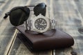 Still life men`s accessories with  watch, leather wallet, and sunglasses on old grunge wooden table. Set of men`s accessories fo Royalty Free Stock Photo