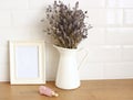 Still life with minimal composition, vase with lavender, dried bouquet, empty vertical wooden picture frame mockup, empty vertical