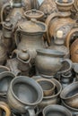 Still life with modern pottery vessels made of clay. Burnt black ceramics. Burned clay jars. vertical photo