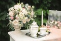 Still life morning of the bride, a dish with a cup of tea, a jewelry box, wedding rings and a bouquet of flowers. Royalty Free Stock Photo