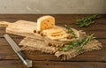 Still life on the morning table. Sliced cheese, olives and rosemary on a wooden kitchen board. Rustic style Royalty Free Stock Photo