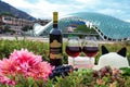 Still life on the nature of grapes, wine, hats and flowers on the background of the glass bridge of the world in Tbilisi, Georgia.