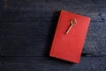 Still life with old book and key on wooden Royalty Free Stock Photo