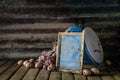 Still life with old frame, eggs, onions, and old blue scales Royalty Free Stock Photo