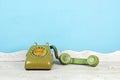 Still life with old green telephone on wooden table. Royalty Free Stock Photo