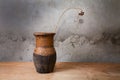 Still-life with an old jug and dry plant on table Royalty Free Stock Photo