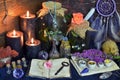 Still life with open diary, flowers, bottles with plants and magic objects on witch table Royalty Free Stock Photo