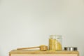 Still life with an open glass jar filled with pasta for soup with a wooden ladle and stainless steel lid Royalty Free Stock Photo
