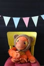 a still life with an orange plush monkey with a teddy bear hat Royalty Free Stock Photo
