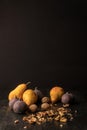 still life with organic autumnal fruits and walnuts on wooden table