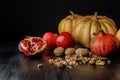 still life with organic autumnal pumpkins, fruits and walnuts