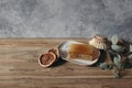 Still life of organic handmade soap bar, wooden brush and dry lemons ruit and eucalyptus on wooden table. Spa, herbal