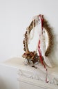 Still life of an ornate brass mirror, with pearls and roses on a