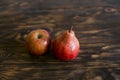 Still life. Pear and apple on a brown background, on a cutting board. Royalty Free Stock Photo