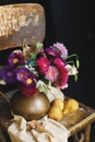 Still life with pears and a bouquet of flowers in a copper jug on a wooden old chair. Royalty Free Stock Photo