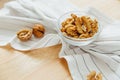 Still life: peeled walnuts in bowl lie on kitchen table. Royalty Free Stock Photo