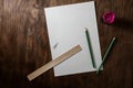 Still life with pencils, piece paper and pencil sharpener on dark brown table with wood texture Royalty Free Stock Photo