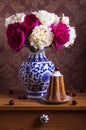 Still life with peonies in a vase and cake Royalty Free Stock Photo