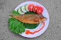 Still life photo of fried milkfish Bandeng Presto on a plate top view Royalty Free Stock Photo