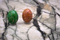 Still life photo of lots of colourful speckled candy covered chocolate easter eggs .