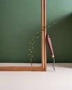 Still life photo. Minimalism still life with a palette knife, green branch and wooden frame. Art supplies