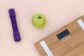 Still Life photography with a green apple, weight and a scale