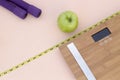 Still Life photography with a green apple, weight tape measure and a scale Royalty Free Stock Photo