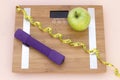 Still Life photography with a green apple, weight tape measure and a scale Royalty Free Stock Photo