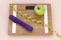 Still Life photography with a green apple, weight tape measure and a scale Royalty Free Stock Photo