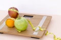 Still Life photography with fruits, tape mesaure and a scale Royalty Free Stock Photo