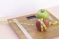 Still Life photography with two apples, tape mesaure and a scale Royalty Free Stock Photo