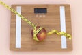 Still Life photography with an apple, tape mesaure and a scale