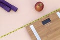 Still Life photography with a red apple, weight tape measure and a scale Royalty Free Stock Photo