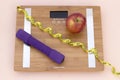 Still Life photography with a red apple, weight tape measure and a scale Royalty Free Stock Photo