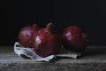 Still life photography shot of three gorgeous pomegranates on a wooden deck Royalty Free Stock Photo