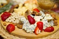 Still life picture with cheese and strawberries